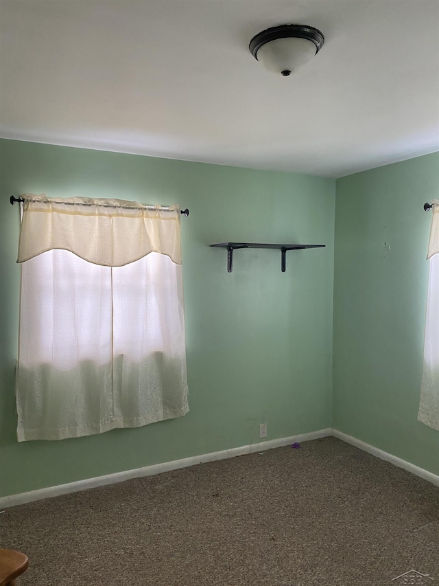 empty room with carpet floors and baseboards