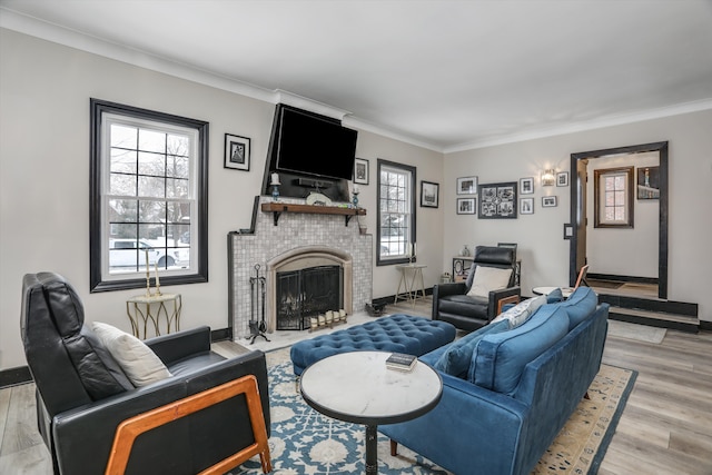 living area featuring a wealth of natural light, a brick fireplace, crown molding, and wood finished floors