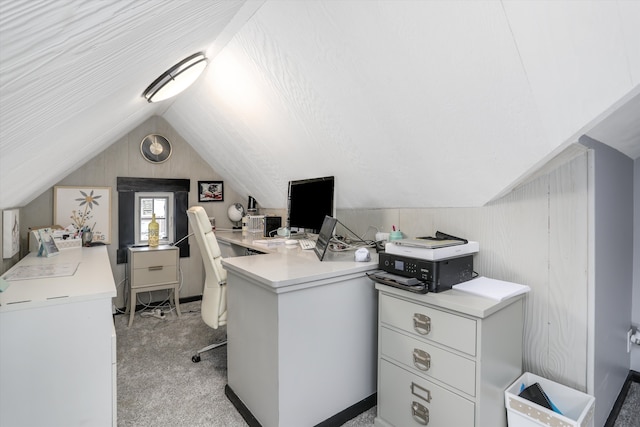 home office with lofted ceiling and light carpet