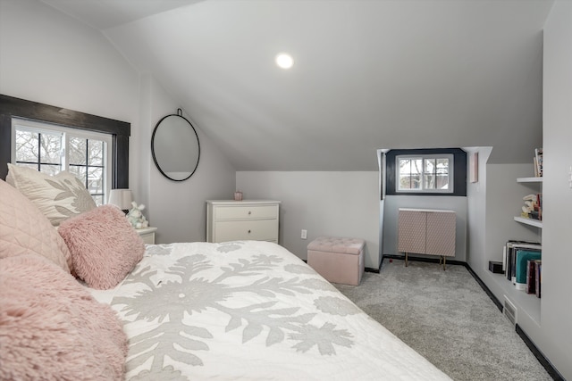 bedroom featuring lofted ceiling, baseboards, and light colored carpet