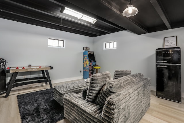 game room with beamed ceiling, light wood-style flooring, and baseboards