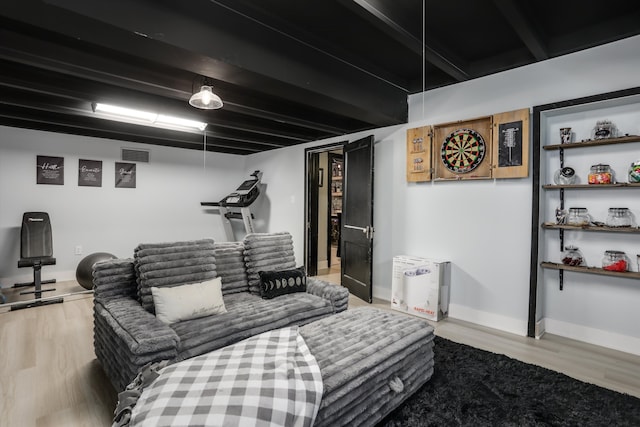 living area featuring visible vents, baseboards, and wood finished floors