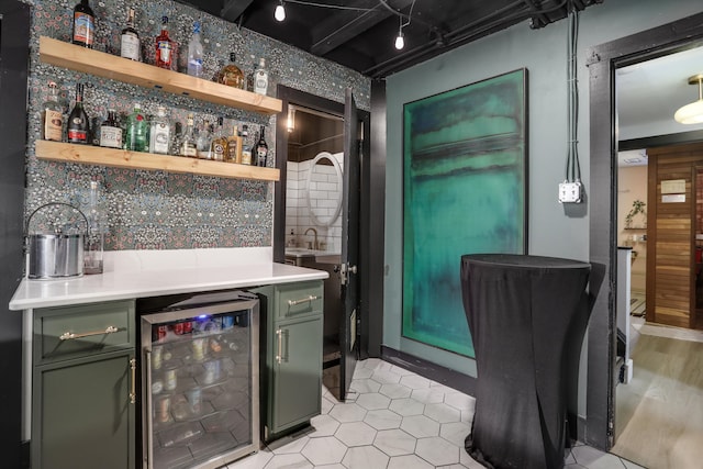 bar featuring decorative backsplash, beverage cooler, and a dry bar