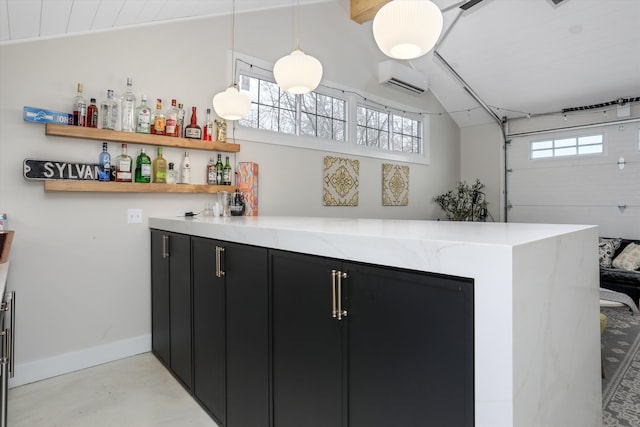 bar with decorative light fixtures, plenty of natural light, finished concrete flooring, and baseboards