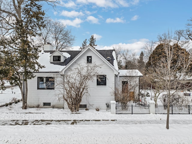 view of front of property featuring a chimney and fence