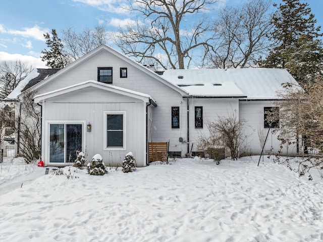 view of snow covered rear of property