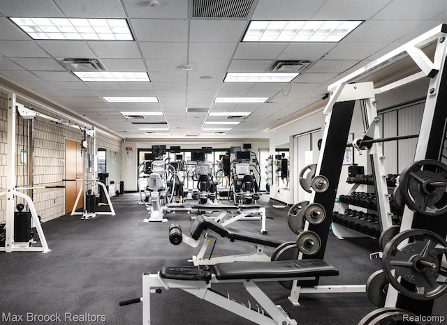 gym featuring visible vents and a drop ceiling