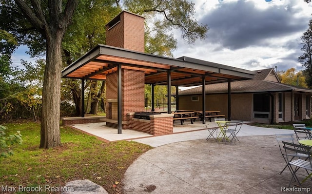 view of patio featuring area for grilling and a fireplace