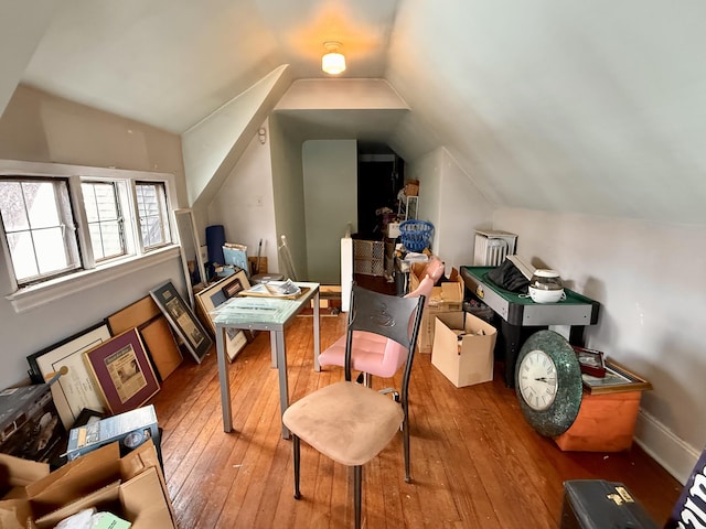 bonus room featuring vaulted ceiling, light wood-style flooring, and baseboards