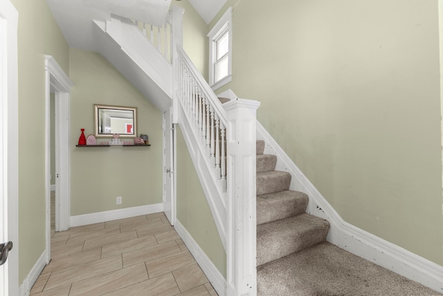 stairway with baseboards and wood finish floors