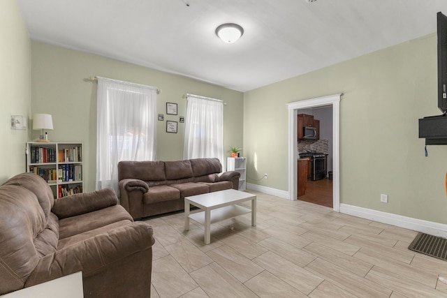 living area with light wood finished floors and baseboards