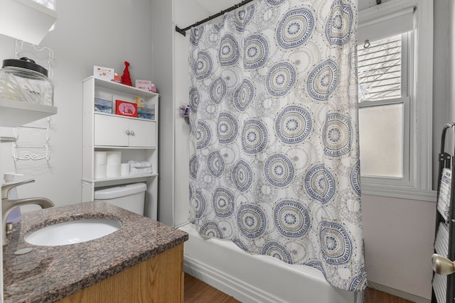 full bathroom with toilet, shower / bath combo with shower curtain, and vanity