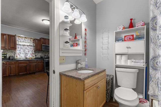 full bathroom with decorative backsplash, vanity, toilet, and wood finished floors