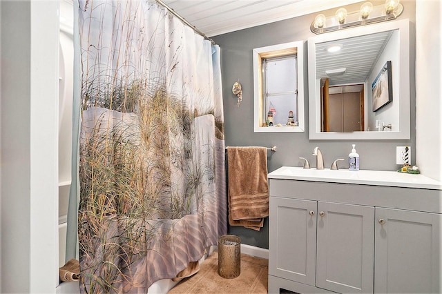 full bathroom with ornamental molding and vanity