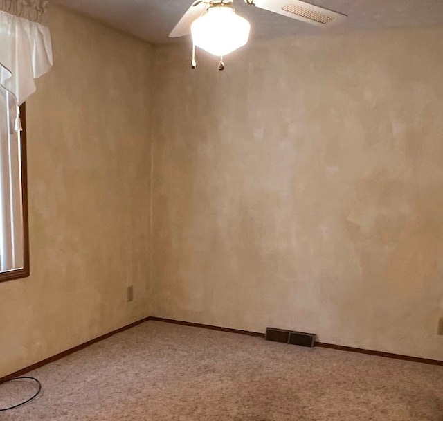 carpeted spare room featuring visible vents