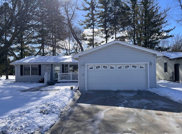 single story home featuring a garage, covered porch, and driveway