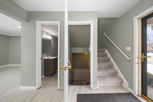 staircase with baseboards and wood finished floors