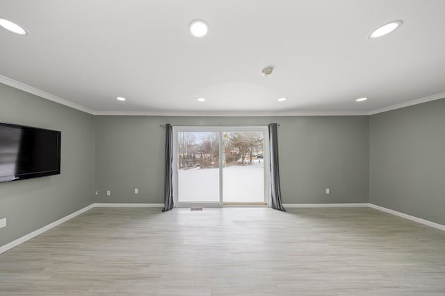 unfurnished living room with baseboards, crown molding, and recessed lighting