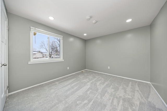 unfurnished room featuring recessed lighting, baseboards, and light colored carpet