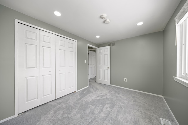 unfurnished bedroom with light carpet, baseboards, visible vents, and recessed lighting