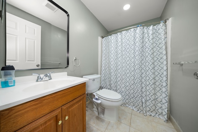 bathroom featuring toilet, vanity, visible vents, and tile patterned floors