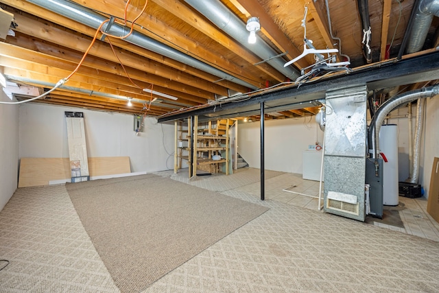 unfinished below grade area featuring washer / clothes dryer, water heater, stairway, and heating unit