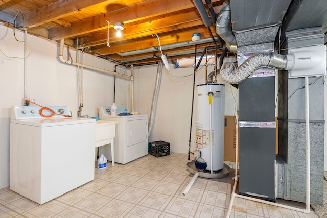 unfinished below grade area with water heater, separate washer and dryer, and tile patterned floors