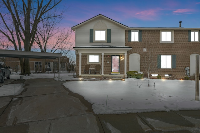 view of front of home with covered porch and brick siding