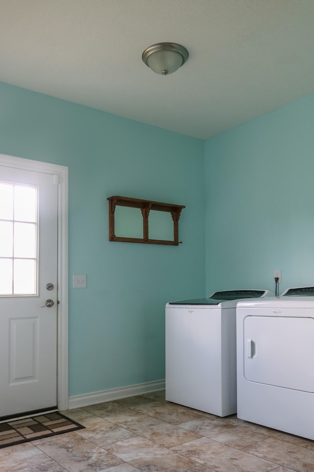 clothes washing area with laundry area, independent washer and dryer, and baseboards