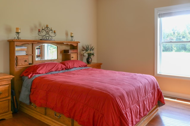 bedroom featuring visible vents and light wood finished floors