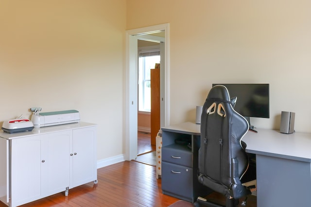 home office with light wood-style floors and baseboards