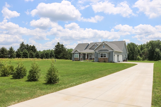 view of front of property with concrete driveway and a front lawn