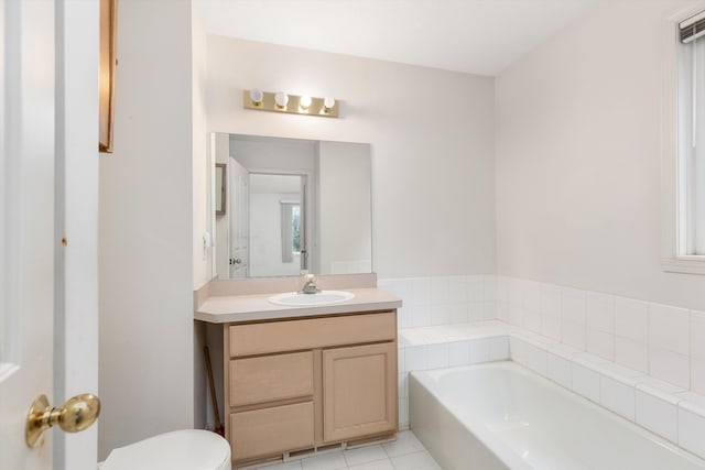 bathroom featuring toilet, a garden tub, tile patterned flooring, and vanity