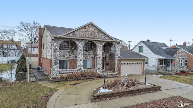 traditional-style house with concrete driveway, stone siding, a chimney, an attached garage, and fence