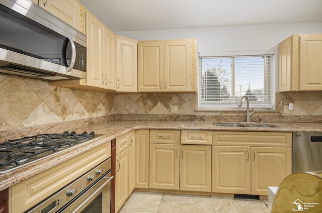 7740 Ternes St, Dearborn, MI 48126 - kitchen featuring light brown cabinets, a sink, appliances with stainless steel finishes, decorative backsplash, and light stone countertops