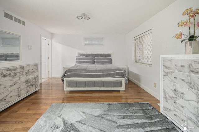 7740 Ternes St, Dearborn, MI 48126 - bedroom with baseboards, visible vents, and wood finished floors