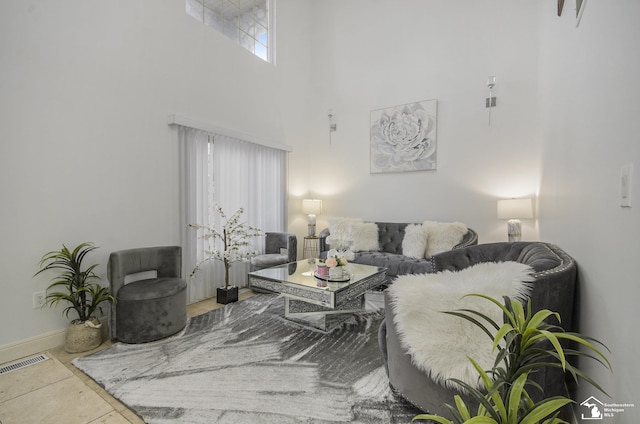 7740 Ternes St, Dearborn, MI 48126 - living area featuring baseboards, visible vents, and a high ceiling