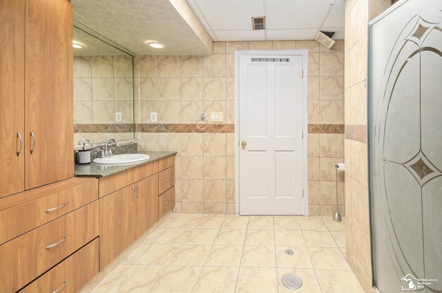 7740 Ternes St, Dearborn, MI 48126 - full bathroom with tile patterned floors, visible vents, tile walls, and vanity