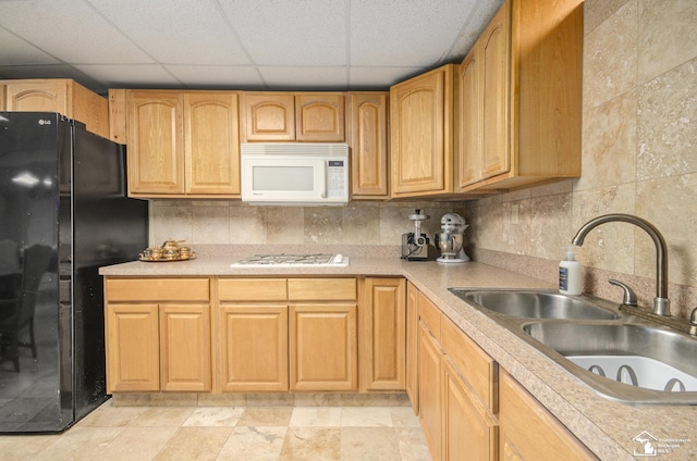 7740 Ternes St, Dearborn, MI 48126 - kitchen featuring tasteful backsplash, white microwave, freestanding refrigerator, a sink, and gas cooktop