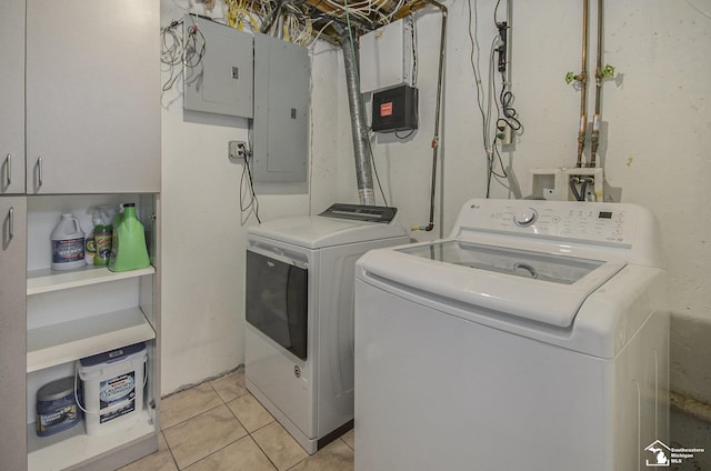 7740 Ternes St, Dearborn, MI 48126 - laundry room featuring washing machine and dryer, electric panel, cabinet space, and light tile patterned floors