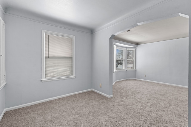 unfurnished room with baseboards and light colored carpet