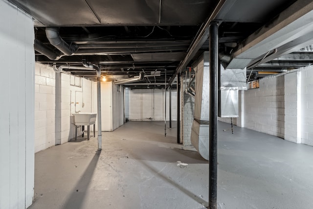 unfinished basement featuring a sink