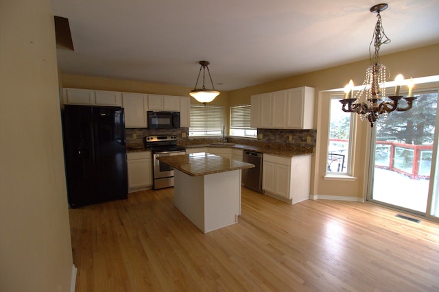 kitchen featuring black appliances, a sink, visible vents, and white cabinetry