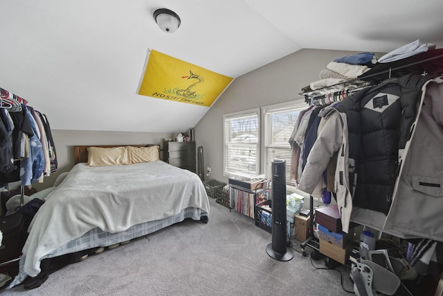 bedroom with lofted ceiling and carpet flooring