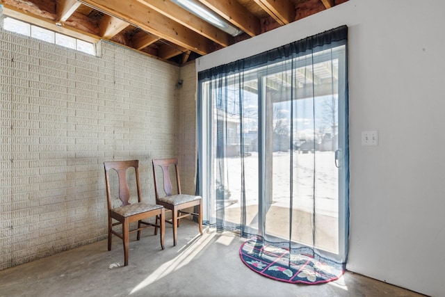 living area featuring a wealth of natural light and concrete floors