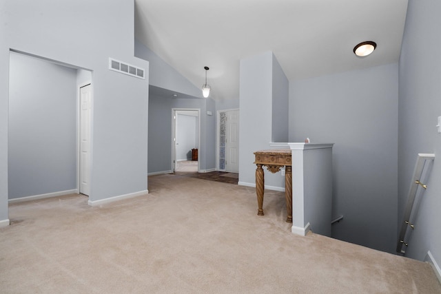 interior space featuring light carpet, high vaulted ceiling, baseboards, and visible vents