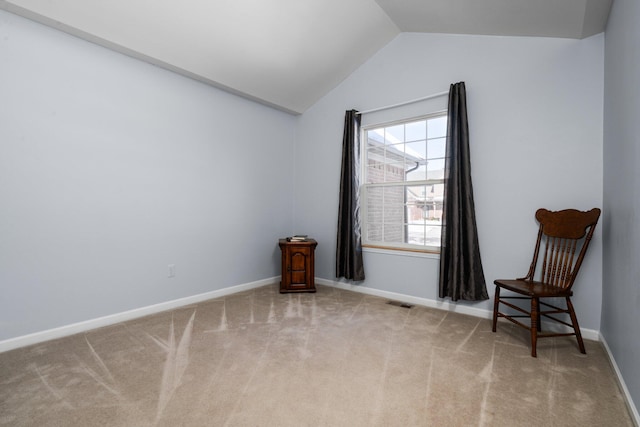 unfurnished room featuring light carpet, vaulted ceiling, visible vents, and baseboards