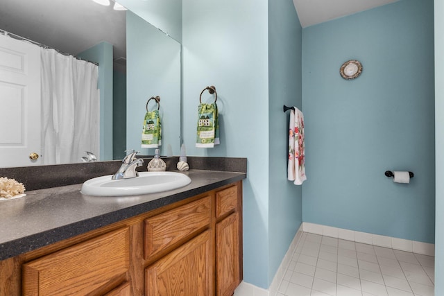 bathroom featuring baseboards, vanity, and tile patterned floors