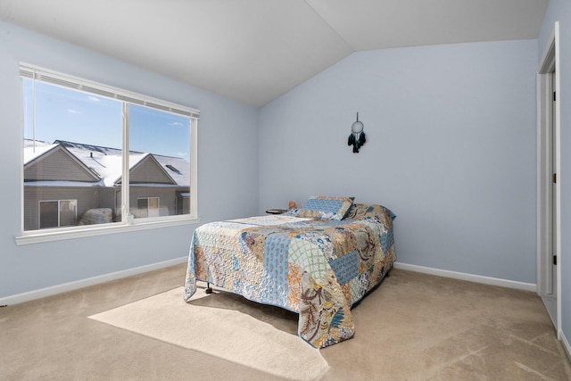 bedroom featuring lofted ceiling, light carpet, and baseboards