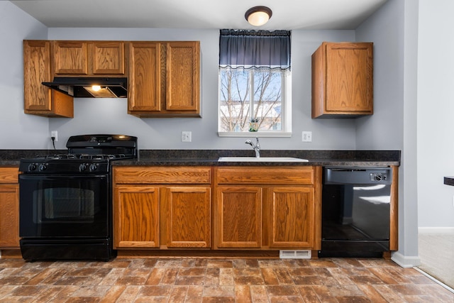 kitchen with dark countertops, black appliances, under cabinet range hood, and a sink